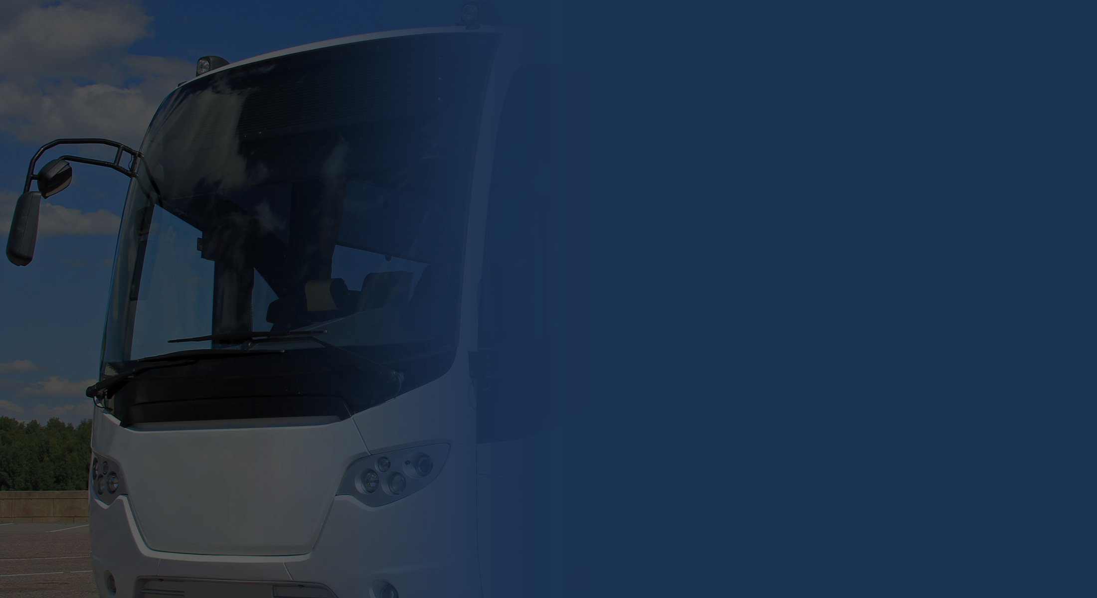 A coach parked under a clear sky