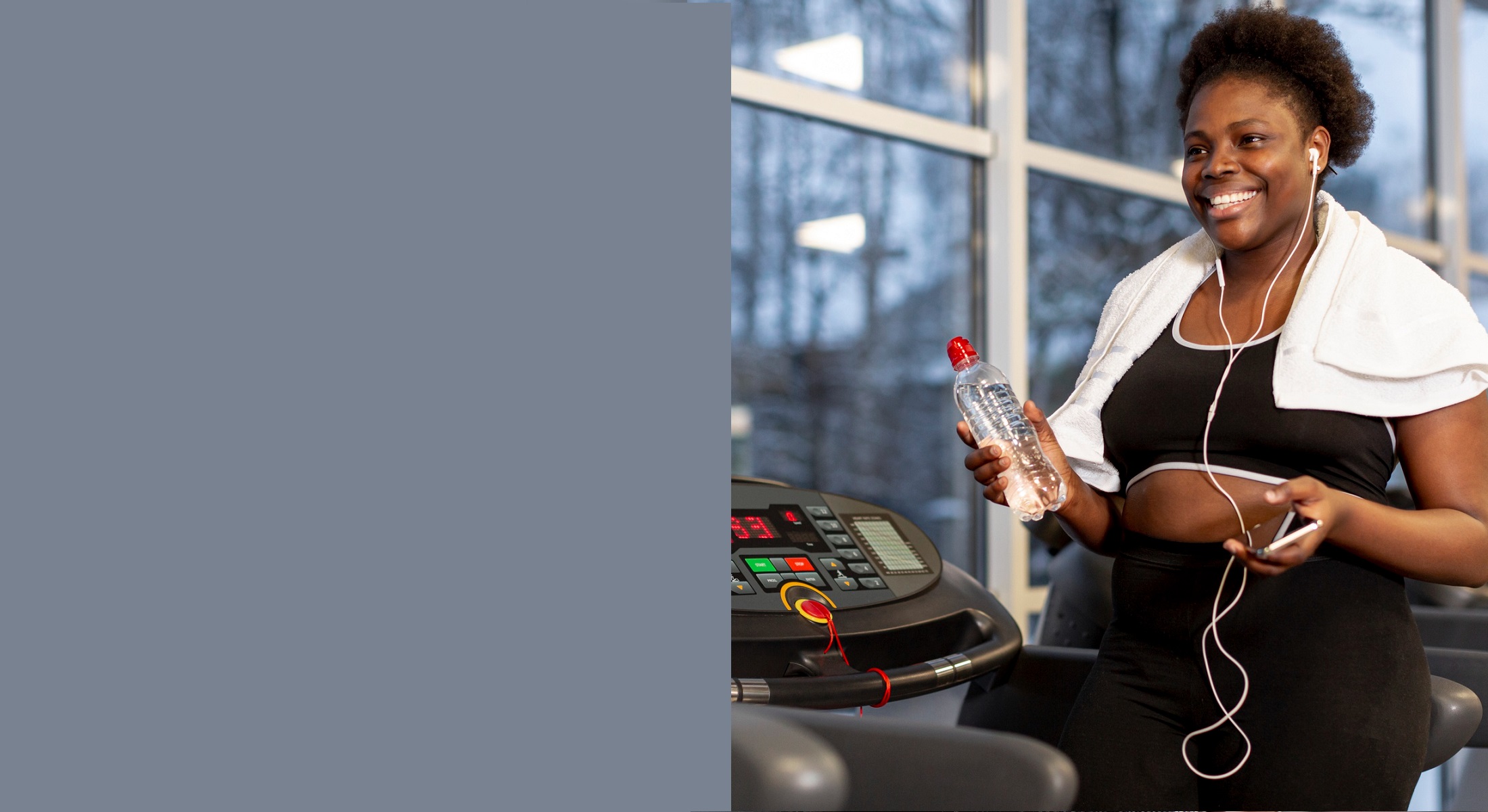 A member on a treadmill with her phone